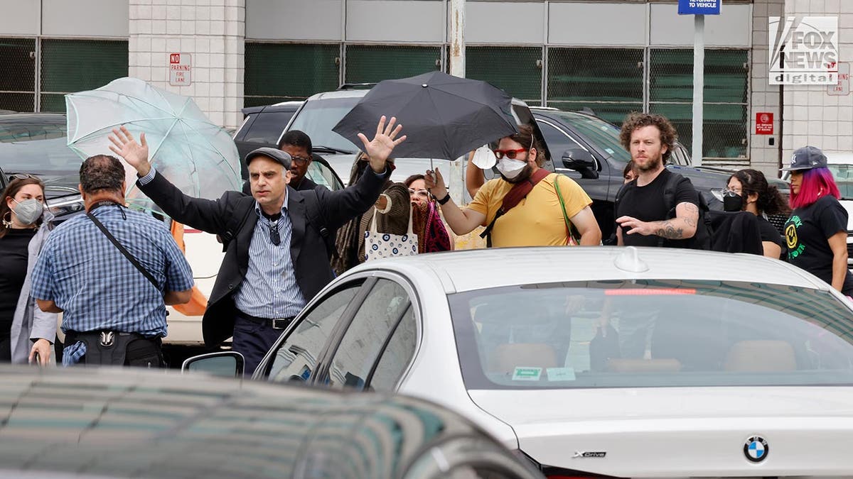 Machete professor is flanked by an entourage