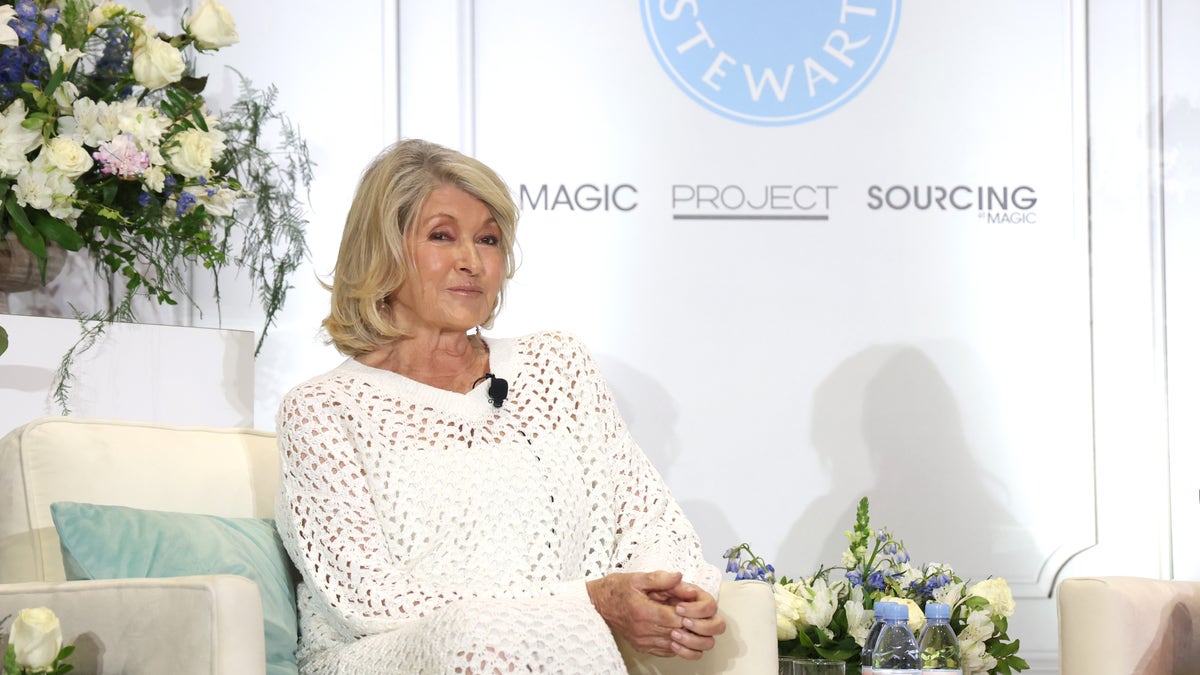 Martha Stewart in all white outfit sitting onstage