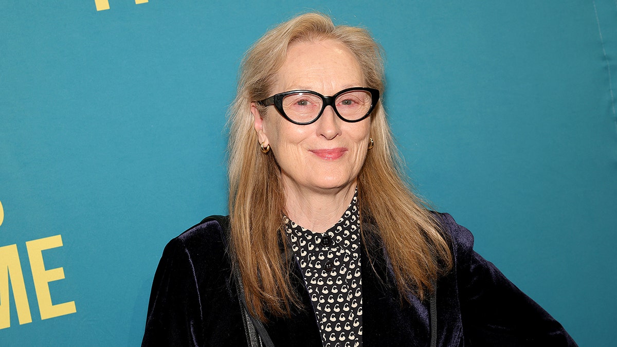 Meryl Streep on the red carpet wearing black framed glasses