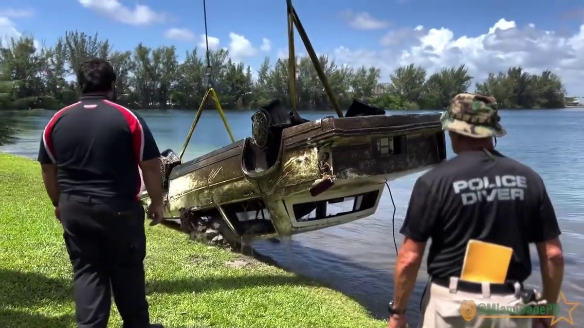 Pictured is a police handout of an old car being pulled from a lake in Doral, Florida