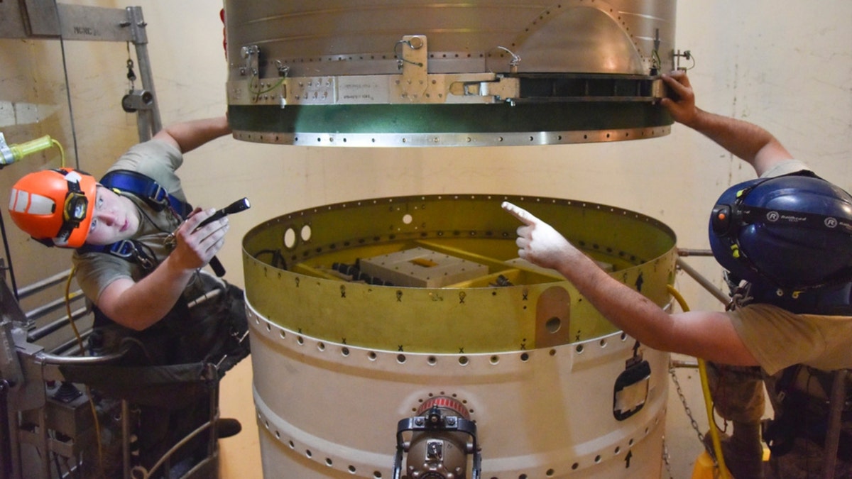 341st Missile Maintenance Squadron technicians connect a re-entry system to a spacer on an intercontinental ballistic missile