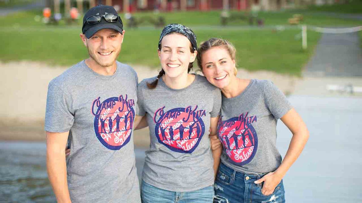 Picture of Isaiah, Sydney, and Morgan Mosher in gray Camp Kita shirts