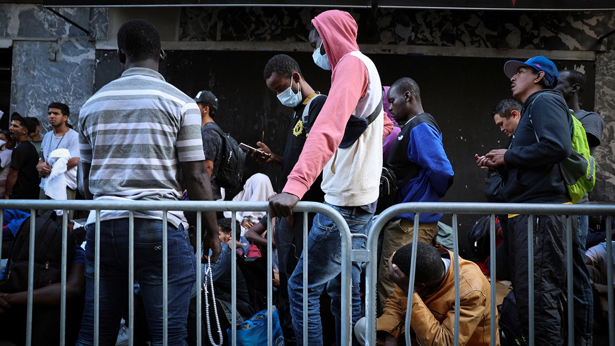 Migrants wait outside New York City hotel