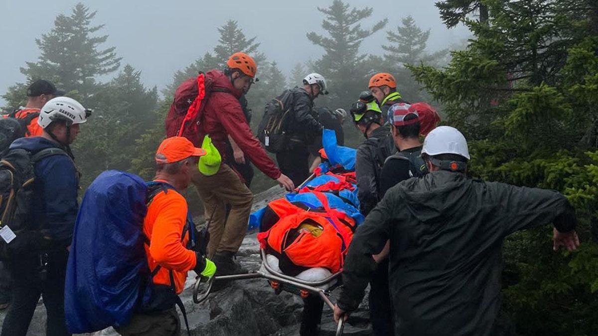 rescuers carrying injured hiker