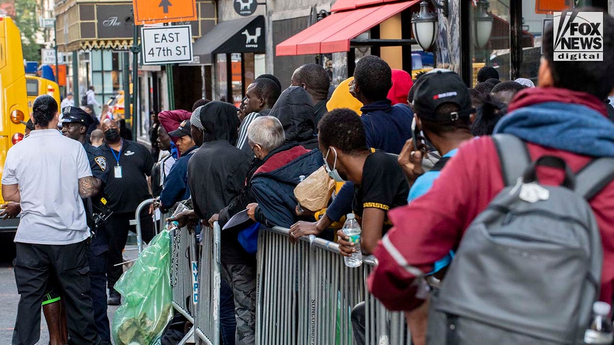 NYC migrants line the street