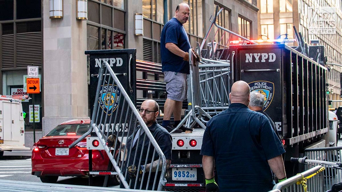 Officials unload additional barricades outside of the Roosevelt Hotel