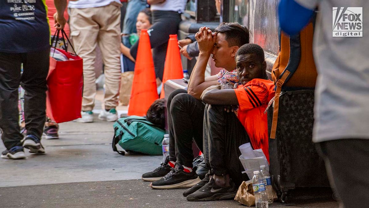 Migrants sitting outside Roosevelt Hotel