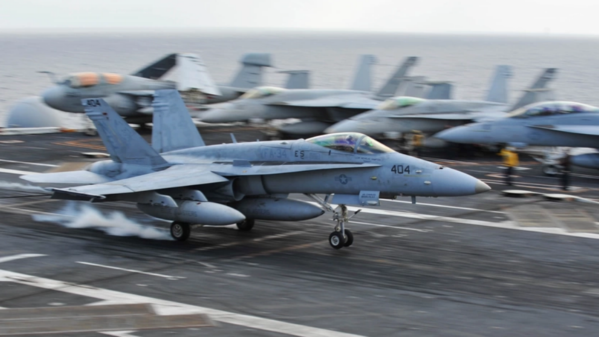 The FA-18 Hornet lands on the flight deck of the USS Ronald Reagan