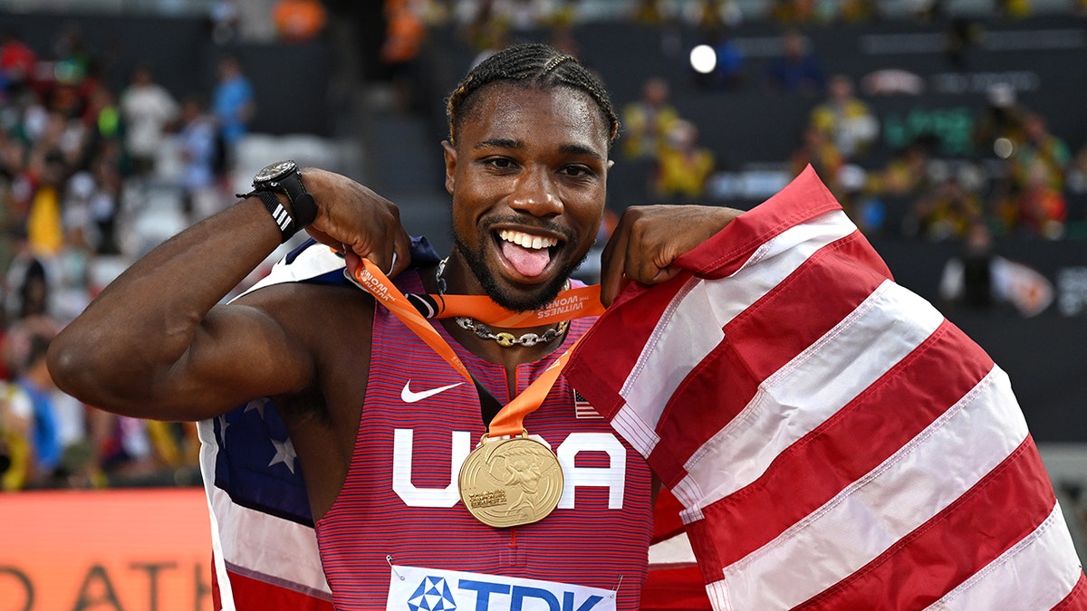 Noah Lyles poses with gold medal