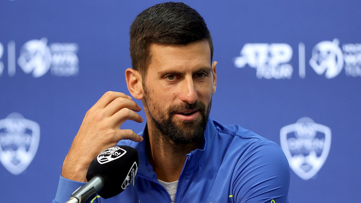Novak Djokovic talks to reporters