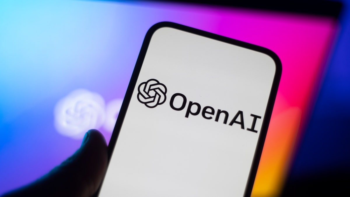 The OpenAI ChatGPT logo is seen on a mobile phone