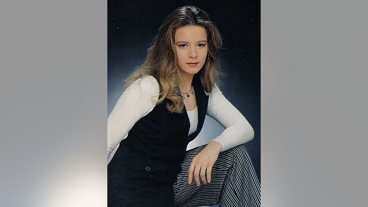 Christie Wilson wearing a white long sleeved shirt, a black vest and checkered pants