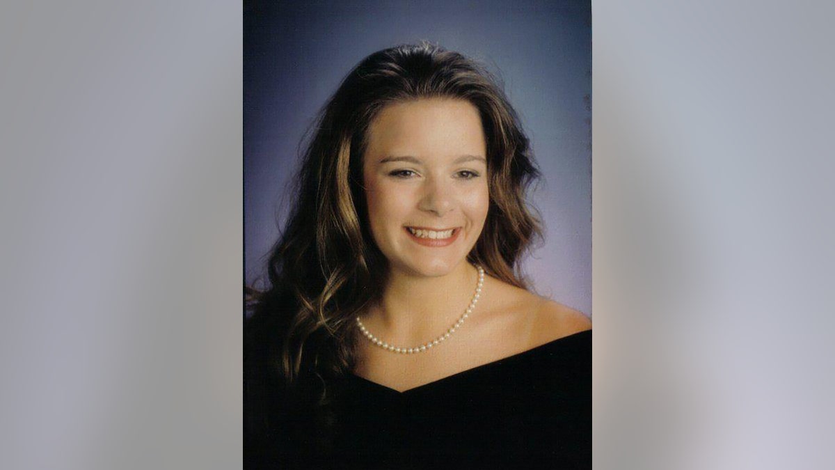 Christie Wilson wearing a black dress and pearls