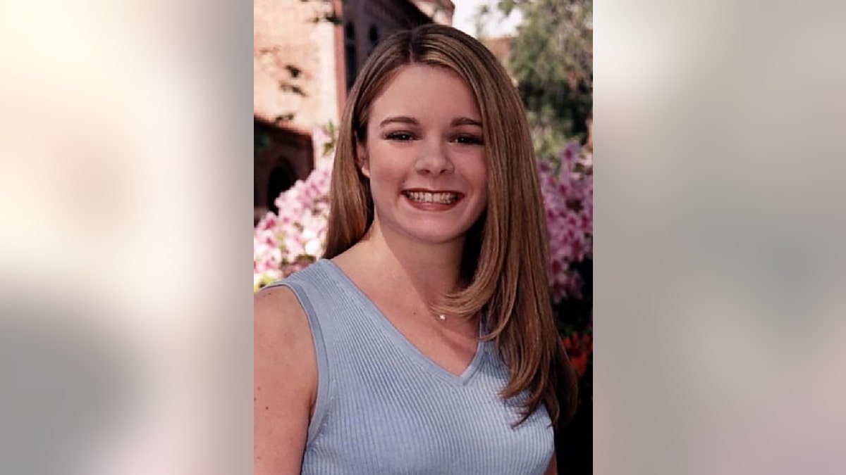 Christie Wilson smiling and wearing a blue sleeveless top