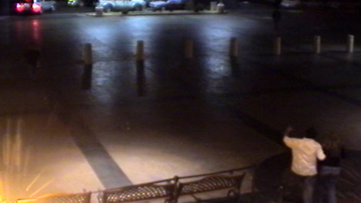 A screengrab of a parking lot with Mario Garcia wearing a white shirt