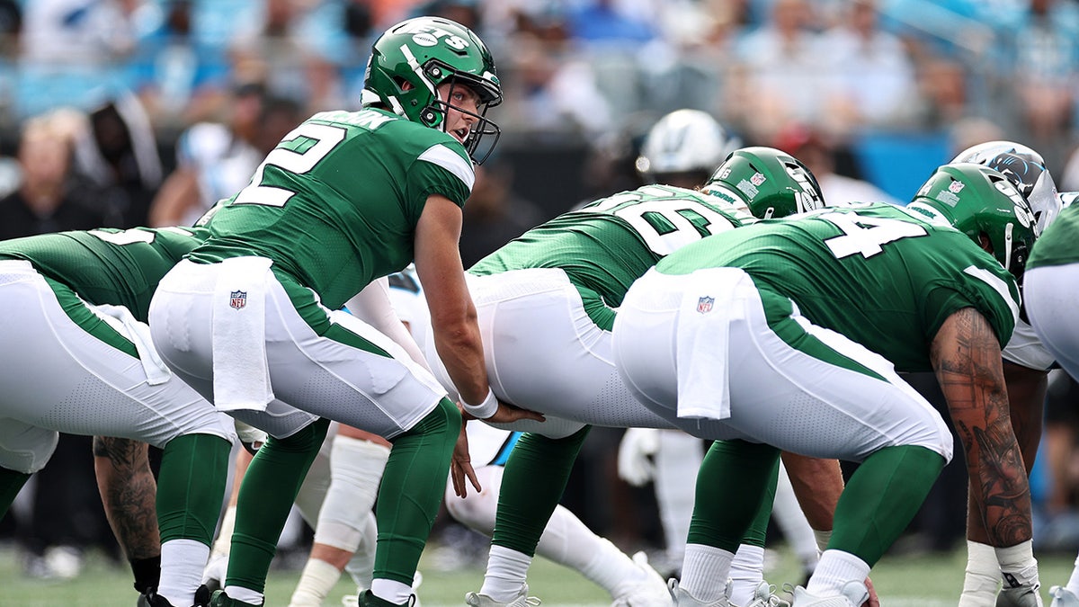 Zach Wilson prepares to snap the ball