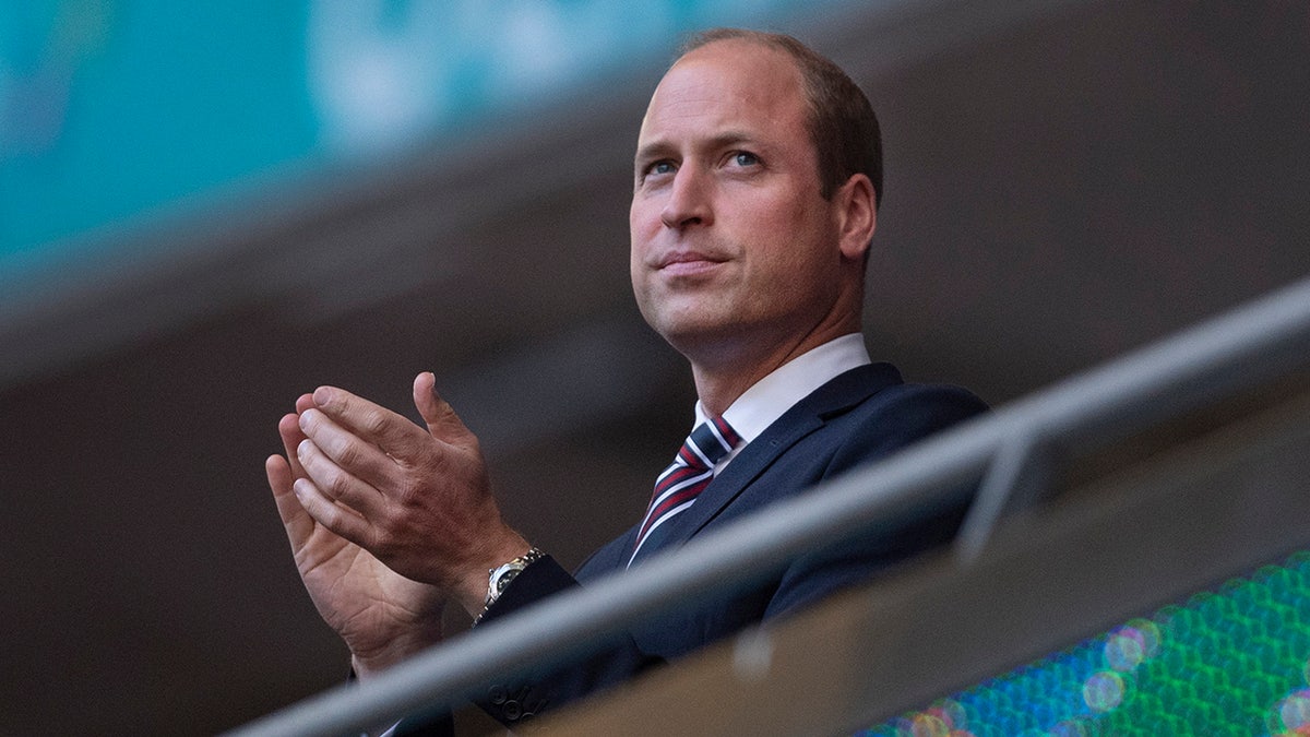 Prince William applauds during a soccer match
