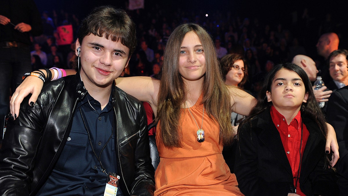 Prince Michael Jackson, Paris Jackson, and Blanket Jackson sitting together.