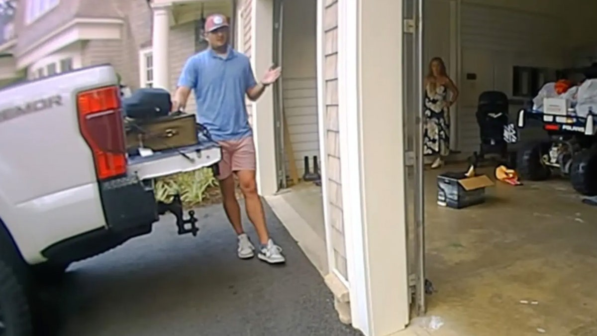 Robert Shiver, wearing a blue shirt behind pickup truck