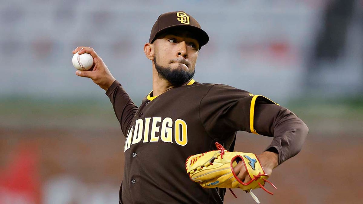 Robert Suarez pitches during a game