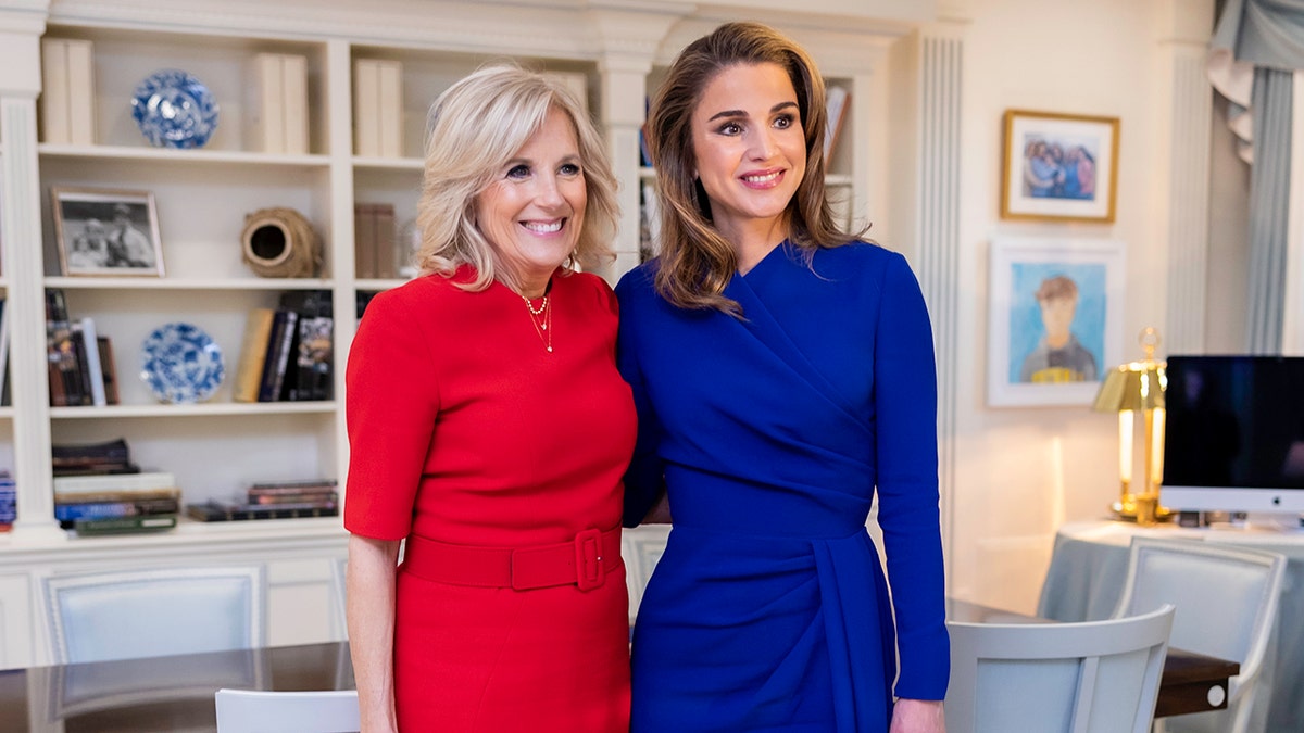 Jill Biden wearing a red dress and Queen Rania of Jordan wearing a blue dress