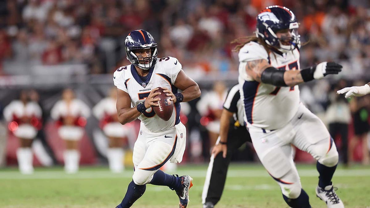 Russell Wilson looks to pass during a game