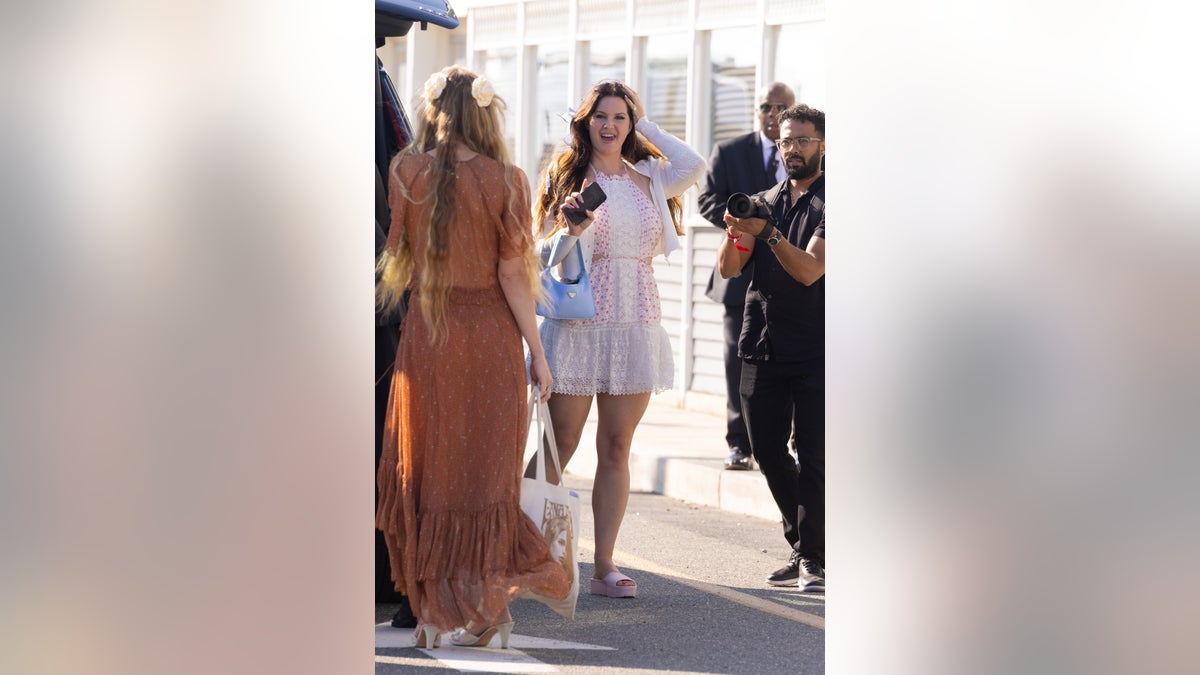 Lana Del Rey smiling at paparazzi camera