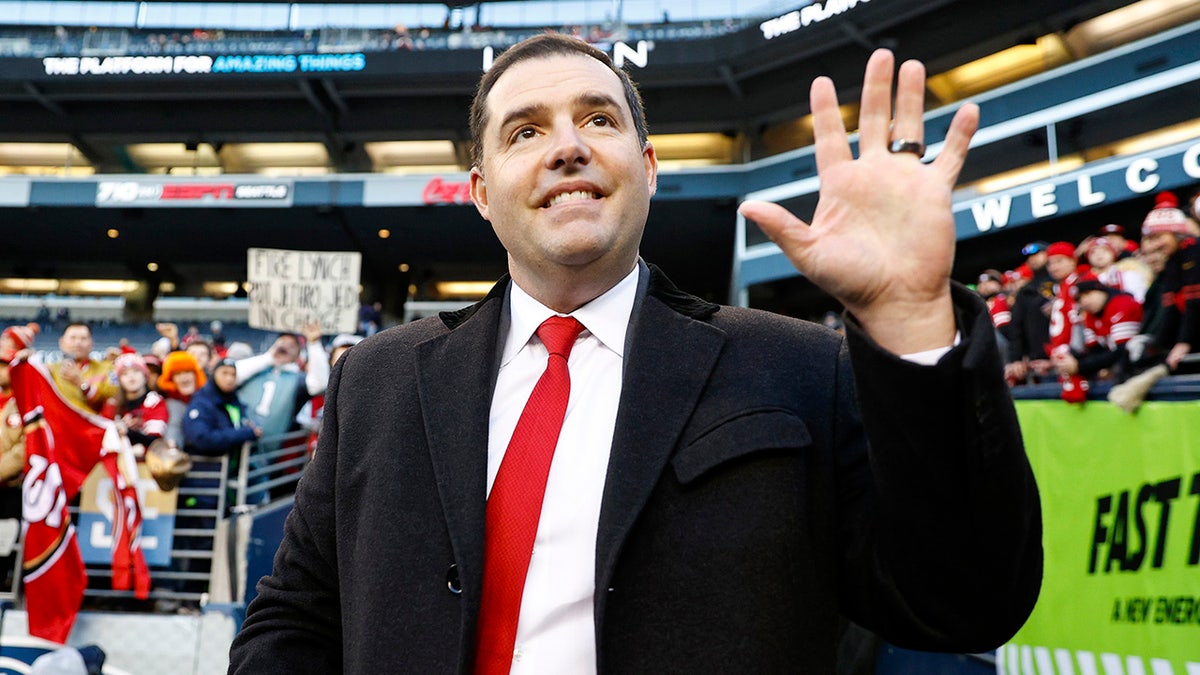 Jed York stands on the football field