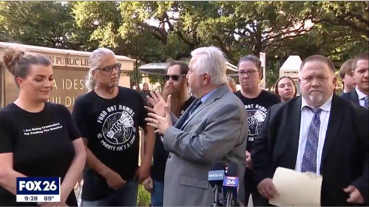 On Friday, July 28, a jury unanimously handed down a ‘not guilty’ verdict to Phillip Picone, second from left, for volunteering to help feed the homeless downtown on March 3. Picone and attorneys Randall Kallinen, center, and Paul Kubosh, left, hold a press conference following Friday's decision.