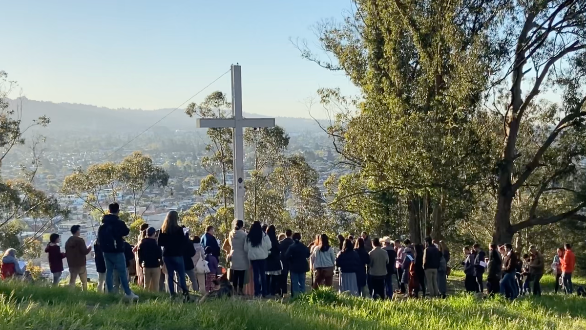 photo of Christians gathered at cross at Albany Hill Park