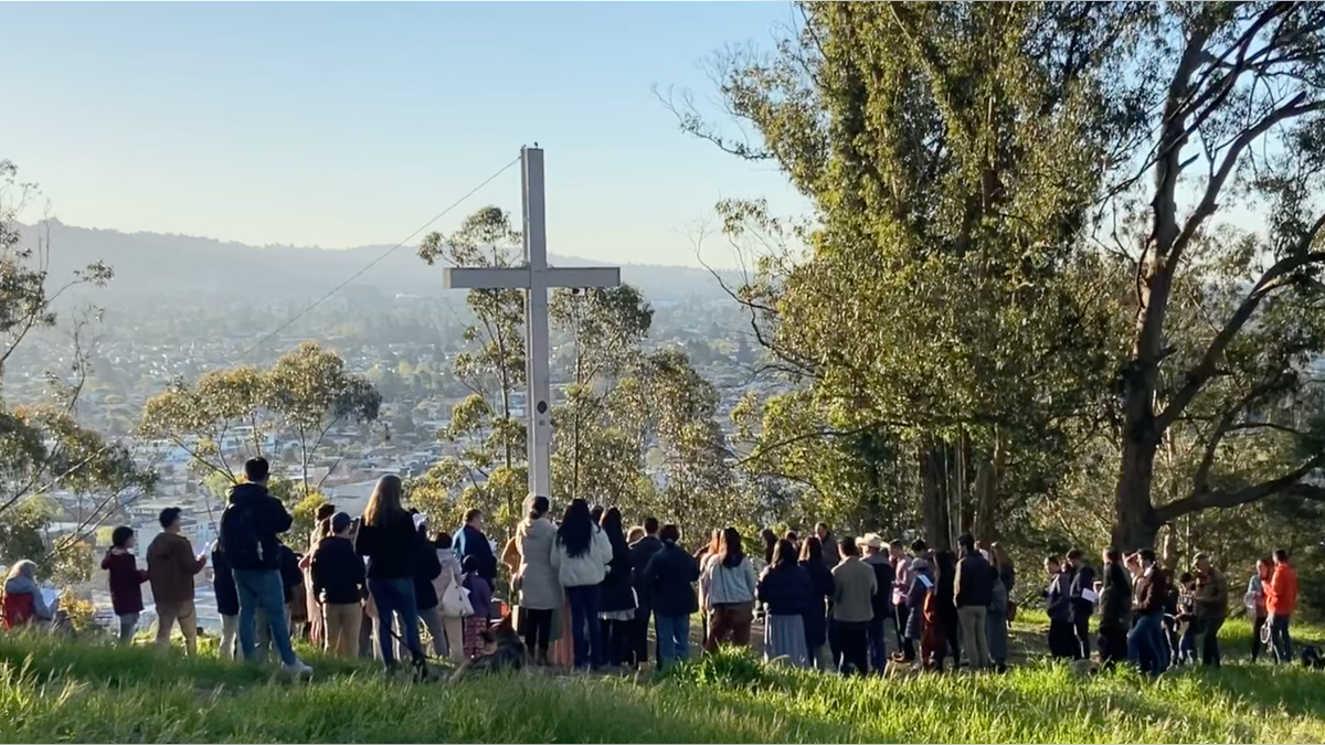 photo of Christians gathered at cross at Albany Hill Park 