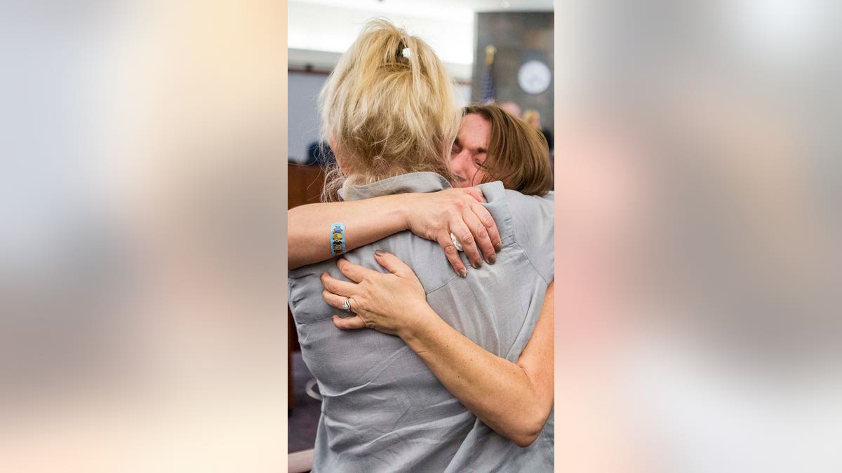 Colleen Beyer hugs a woman in court