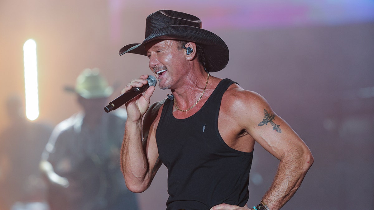Tim McGraw performs in a tank top