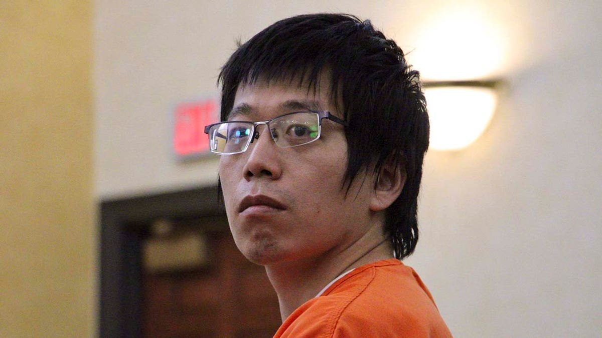 Tailei Qi enters a North Carolina courtroom