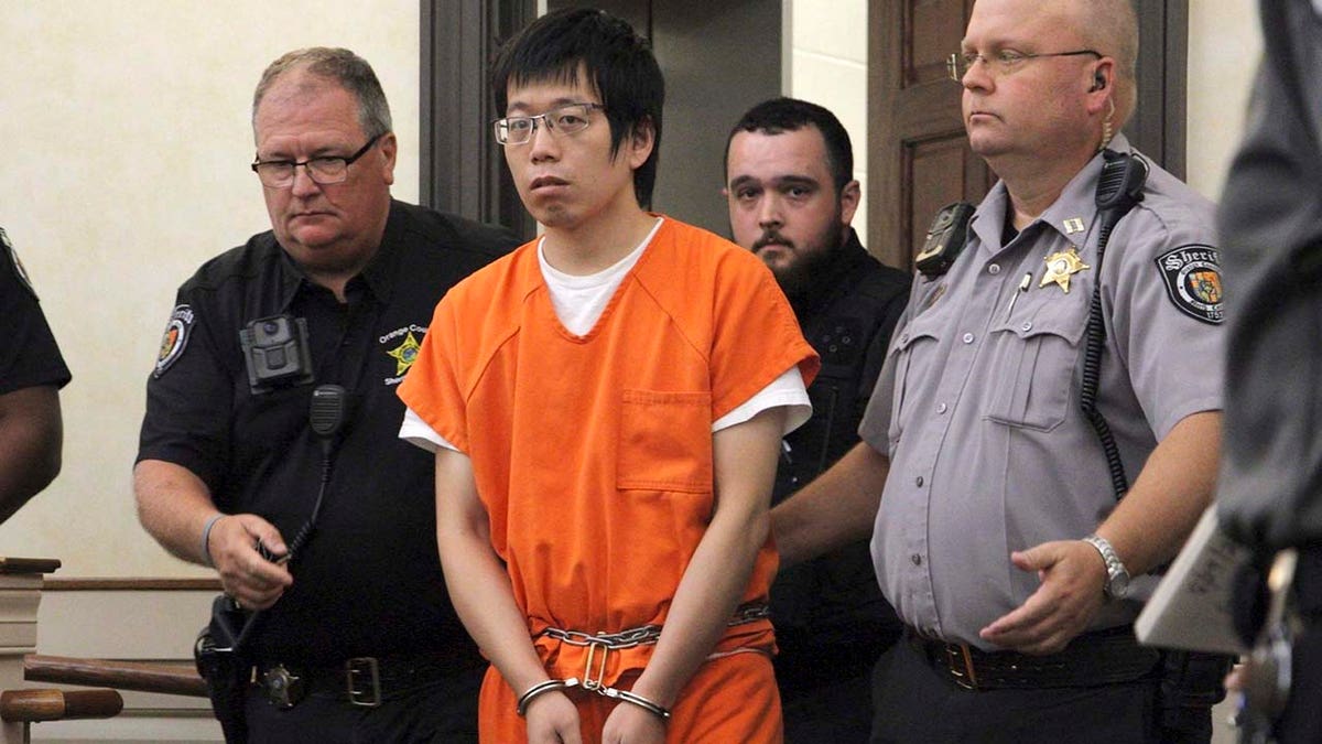 Tailei Qi enters a North Carolina courtroom