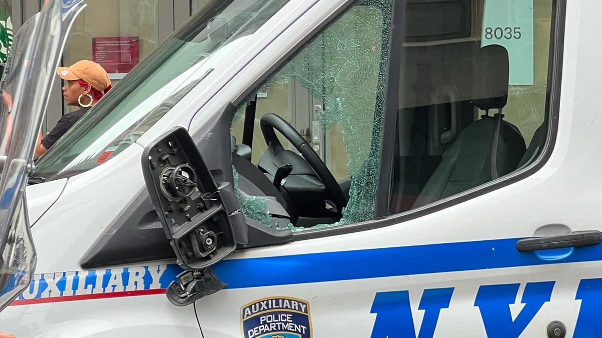 A white NYPD van with broken windows