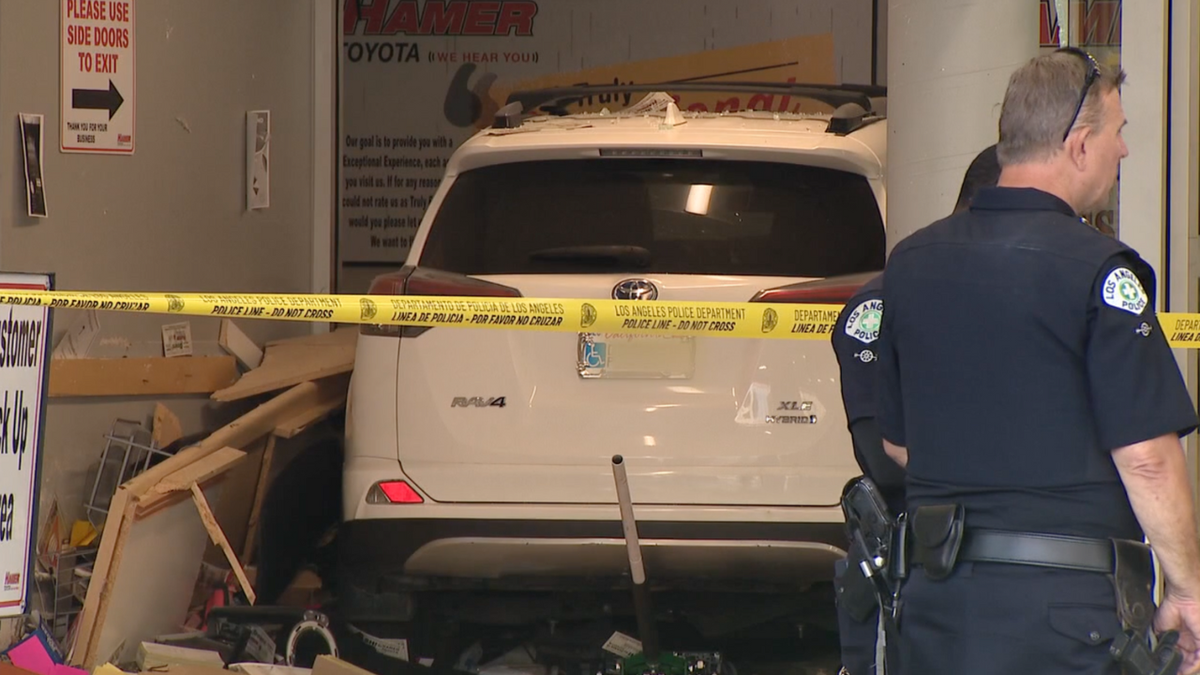 White Toyota RAV4 in dealership collision in LA