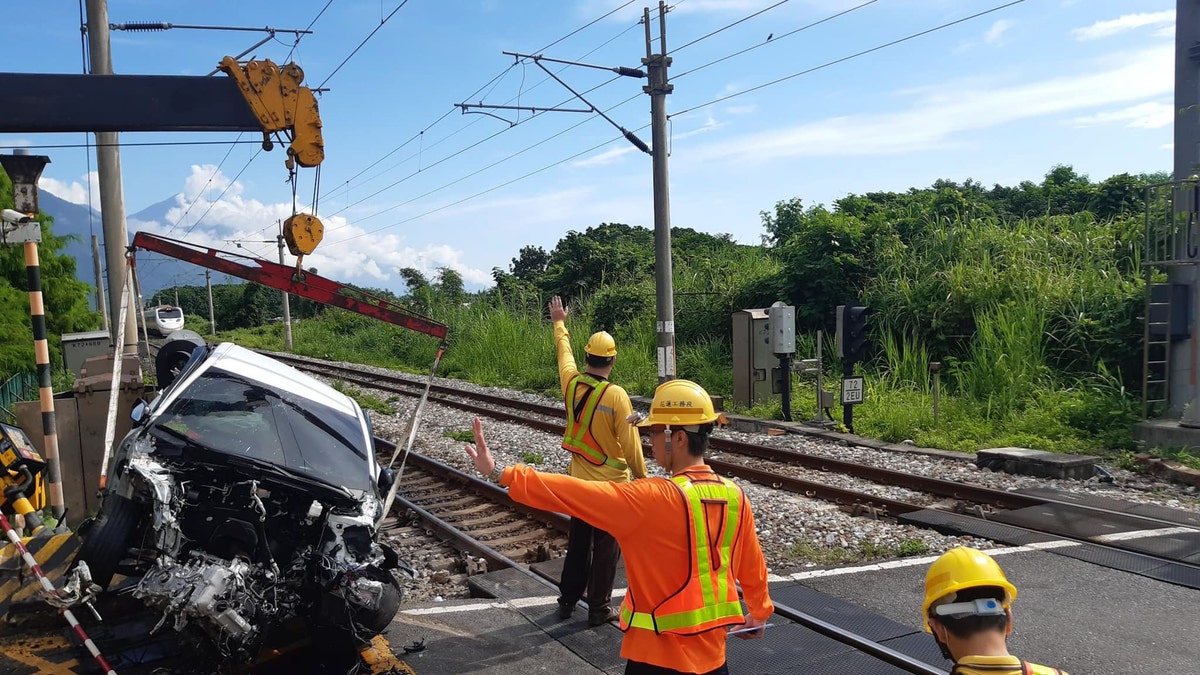 Car removed from site of crash with train