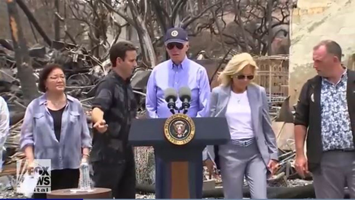Sens. Mazie Hirono and Brian Schatz, left, President Biden behind podium at center