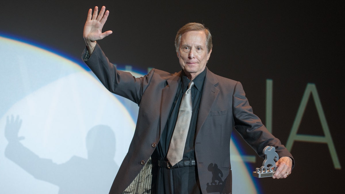 William Friedkin on stage accepting an award
