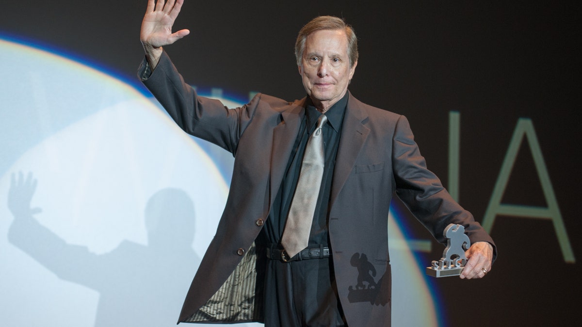 William Friedkin on stage accepting an award