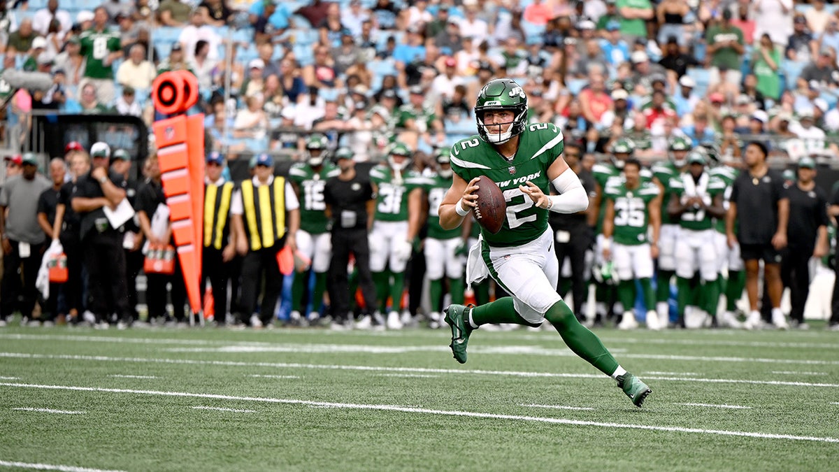 Zach Wilson rolls out during a Jets preseason game 