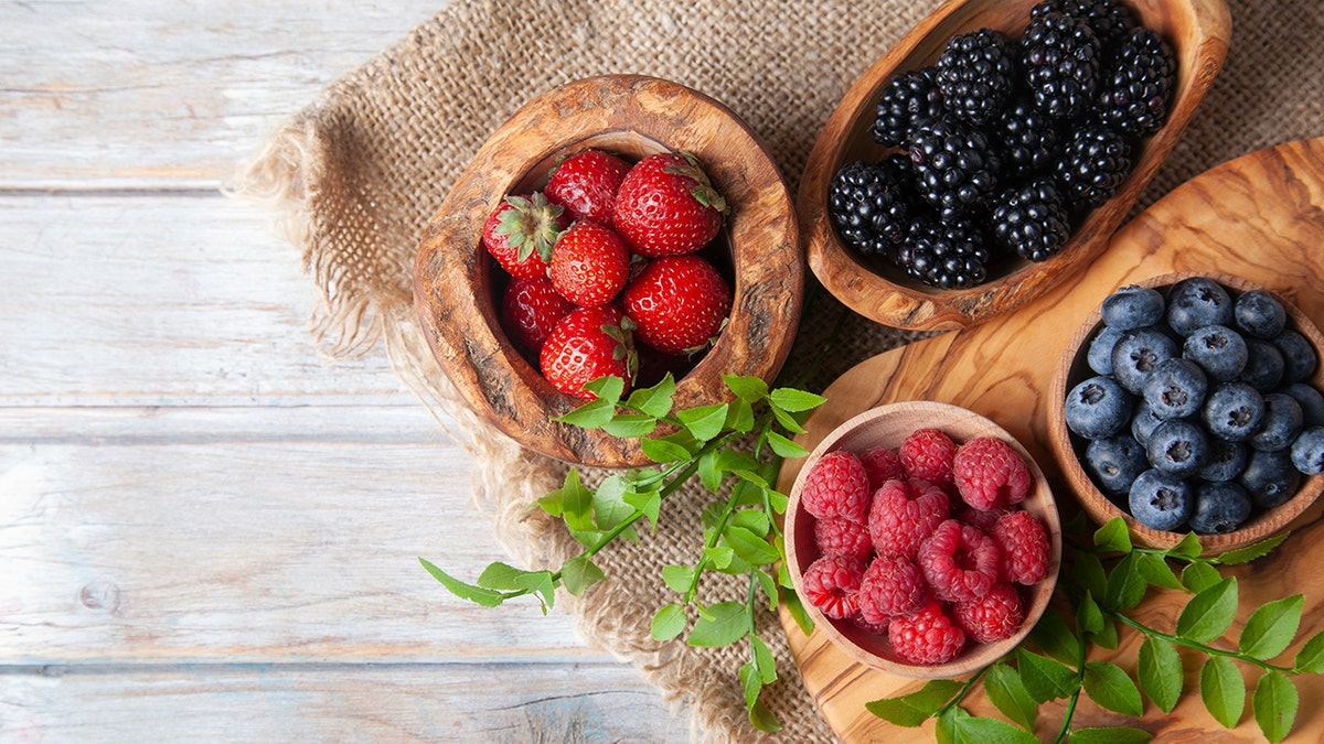 Colorful berries assortment on rustic wooden table