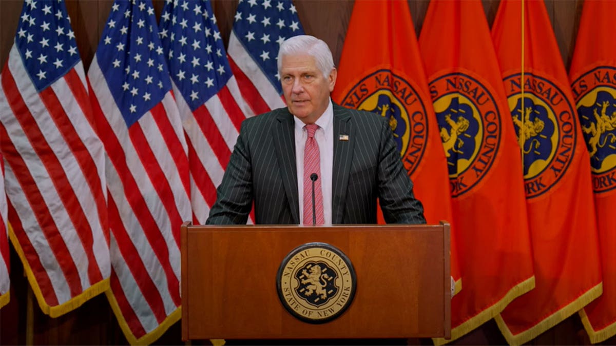 Bruce Blakeman stands in front of podium