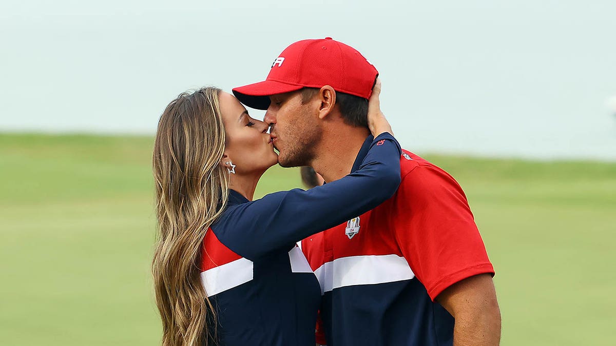 Brooks Koepka celebrates with wife Jena Sims