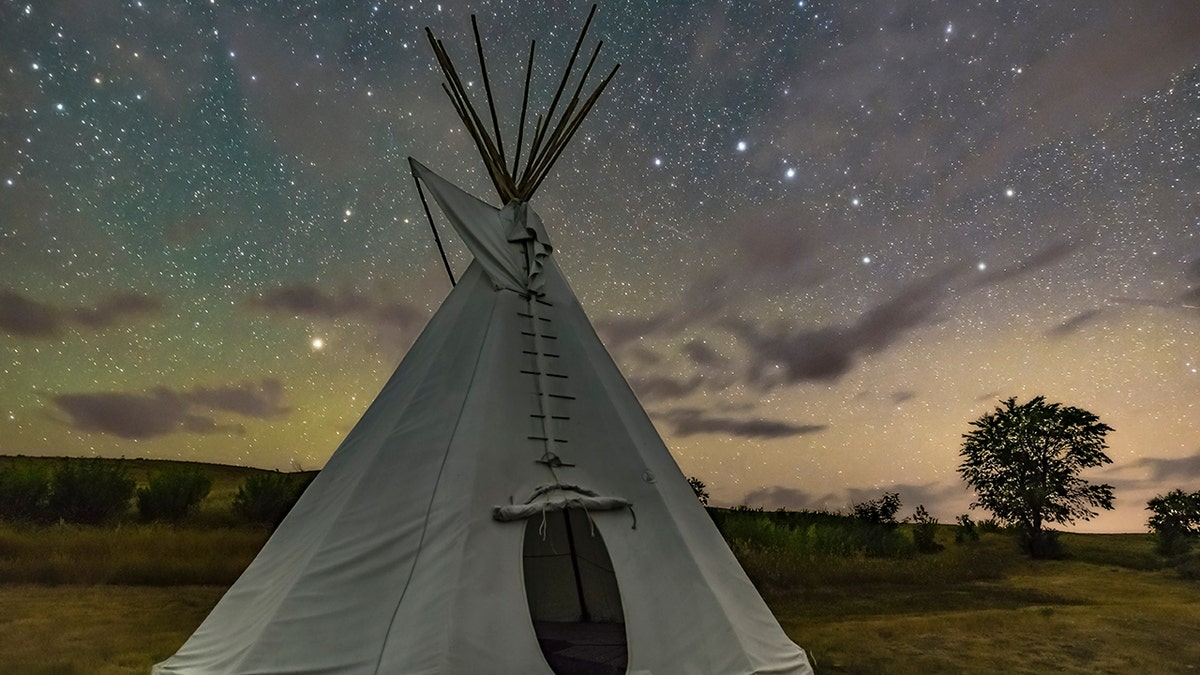 A tent set up under a starry sky