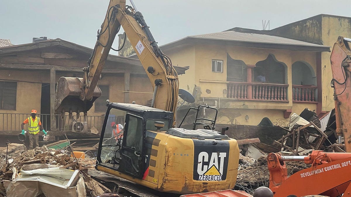 A digger removes debris 