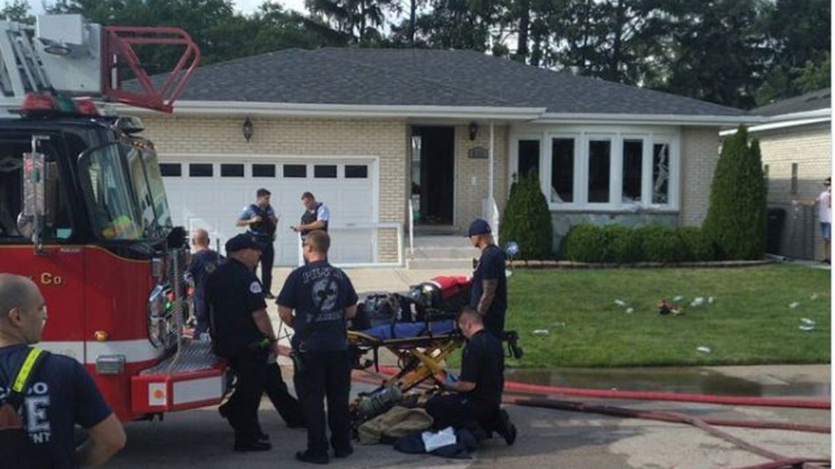 Firefighter on stretcher outside home