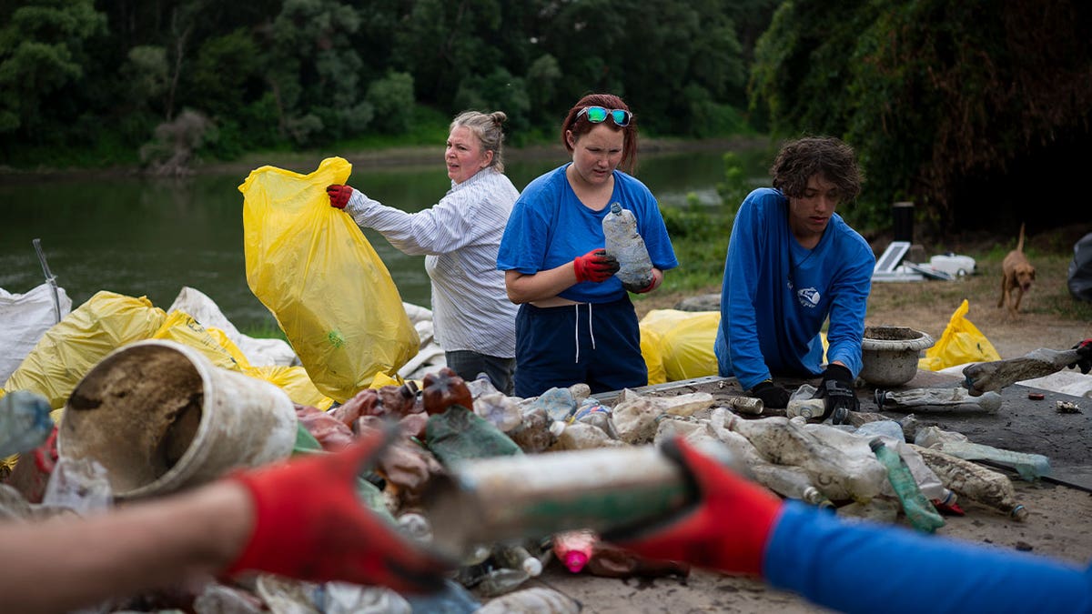 1.	Volunteers in Hungary sort collected litter 