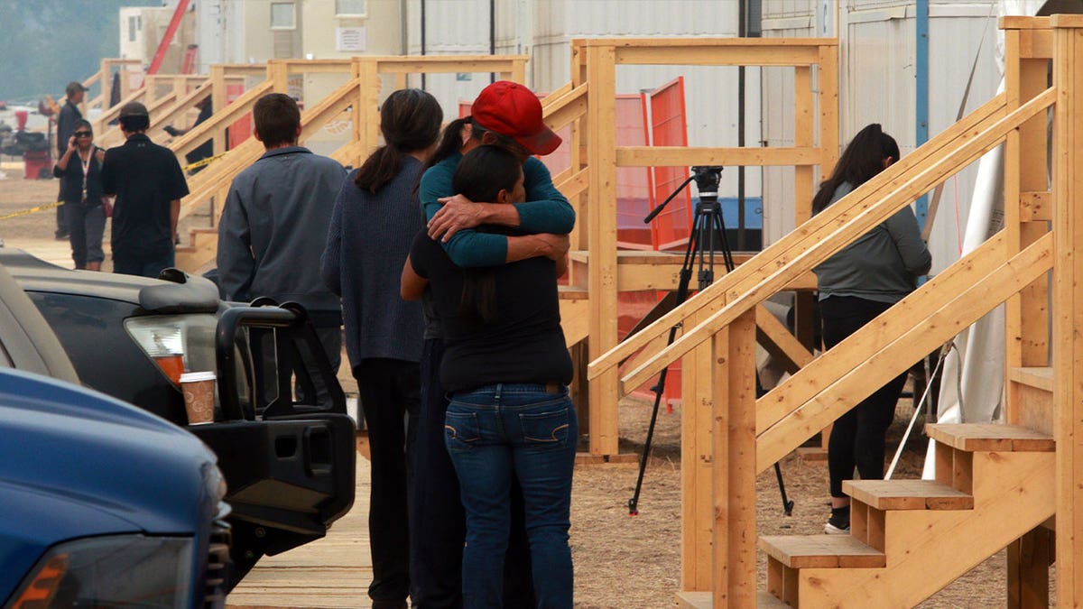 people hugging at shelter